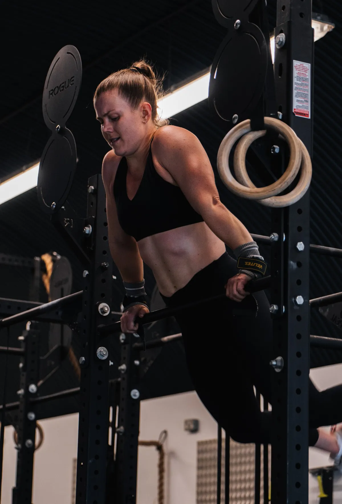 Member performing a dip on the rig in a gymnastics class at Shapesmiths, Clapham Junction
